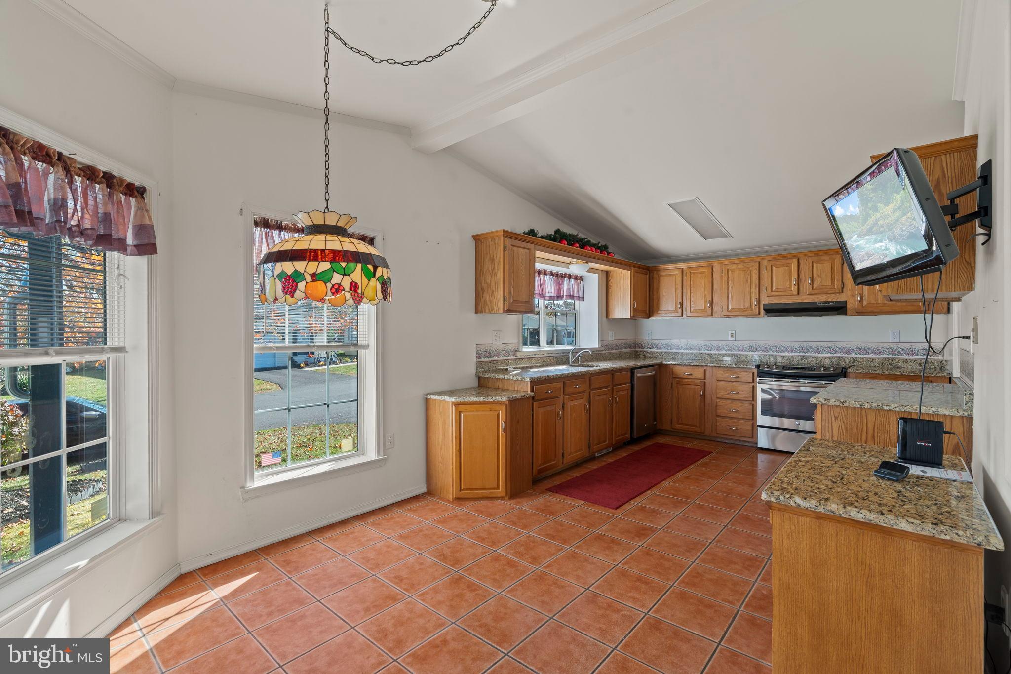 561 Spring Meadow Circle New Hope, PA 18938 - Photo 7 of 23 a kitchen with stainless steel appliances granite countertop a sink a stove and a wooden floors