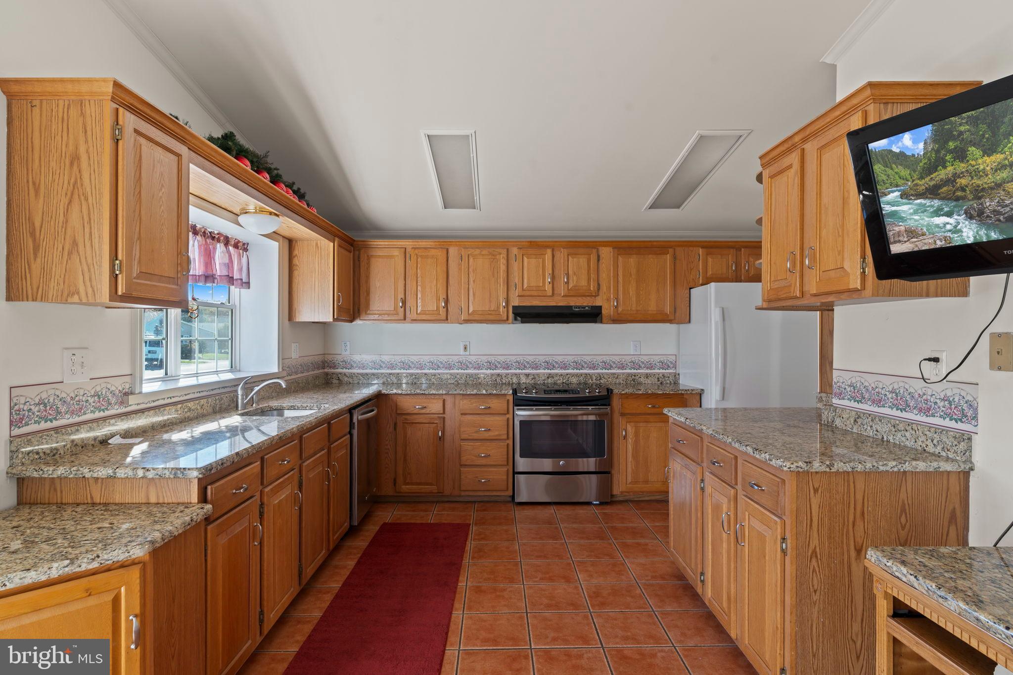 561 Spring Meadow Circle New Hope, PA 18938 - Photo 8 of 23 a kitchen with stainless steel appliances granite countertop a sink stove and cabinets
