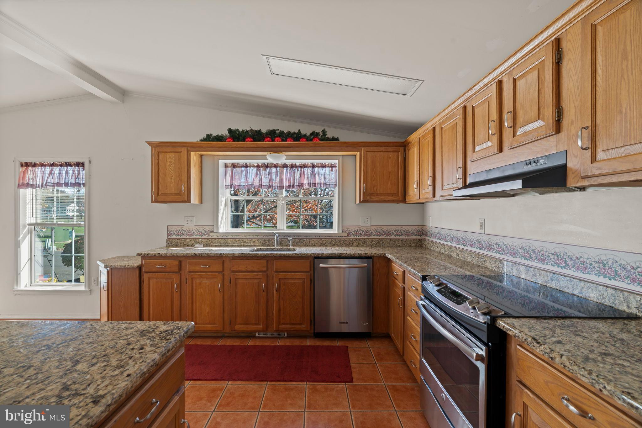 561 Spring Meadow Circle New Hope, PA 18938 - Photo 9 of 23 a kitchen with stainless steel appliances granite countertop a stove a sink and a microwave