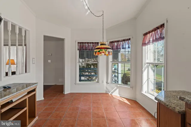 a view of an empty room with window and cabinet