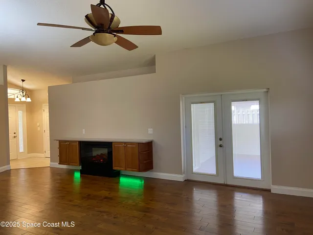 a view of empty room with wooden floor