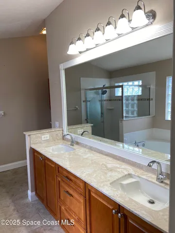 a bathroom with a sink double vanity and a mirror