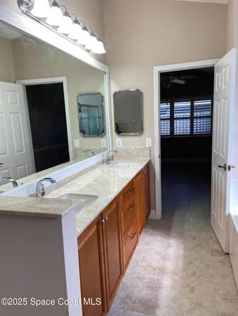 a bathroom with a double vanity sink and mirror