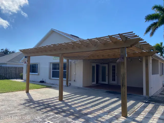a view of a house with wooden fence