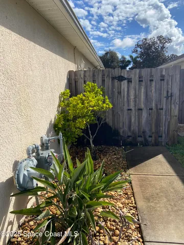 a view of a backyard with chairs