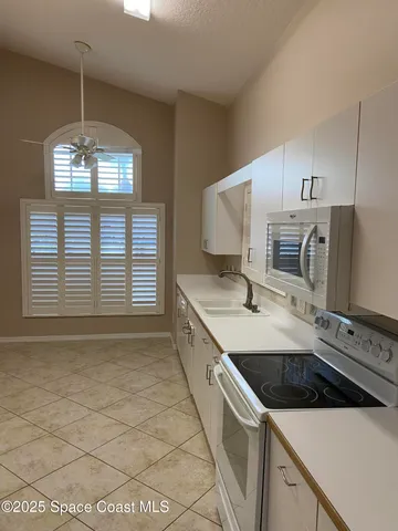 a kitchen with a sink cabinets and window