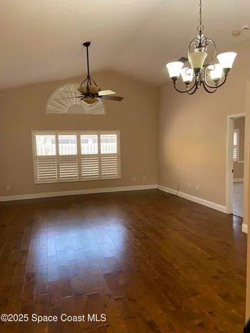 a view of a room with wooden floor
