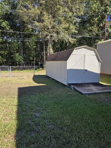 a view of a backyard with swimming pool