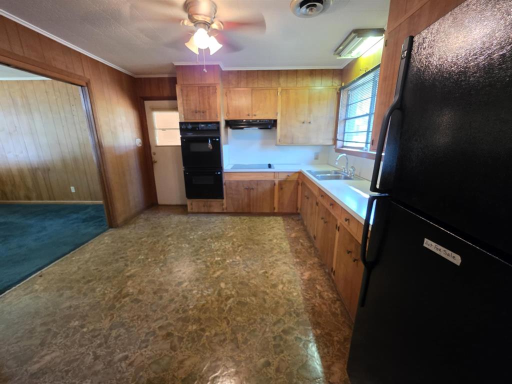 123 Frank Drive Logansport, LA 71049 - Photo 20 of 32 a kitchen with granite countertop a refrigerator a stove top oven a sink and dishwasher