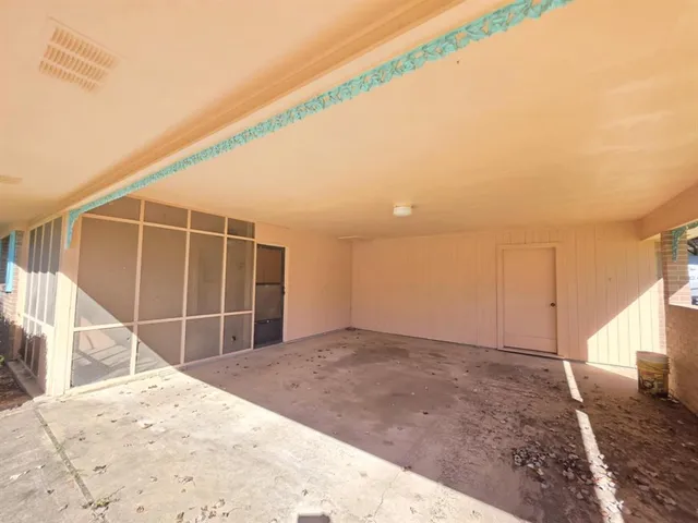 a view of a room with a wooden floor and fence
