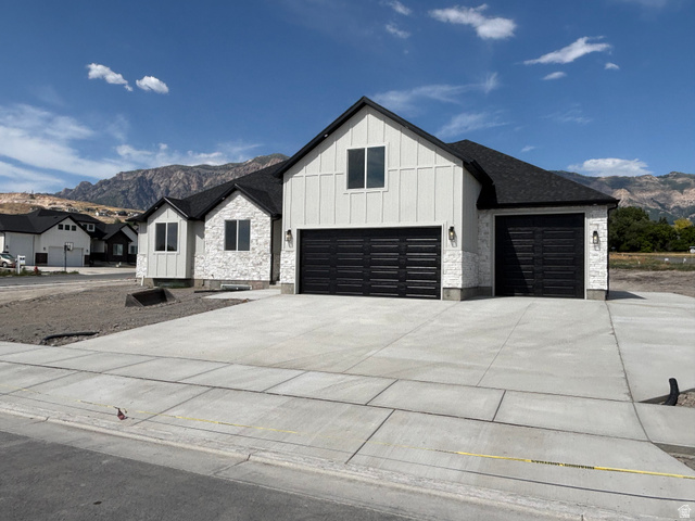1184 West 3250 North Ogden, UT 84414 - Photo 2 of 69 Modern farmhouse exterior featuring white board and batten siding, stone facade accents, and a dark shingle roof