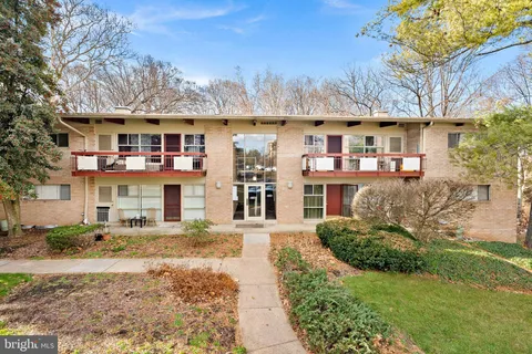 a front view of a building with a yard