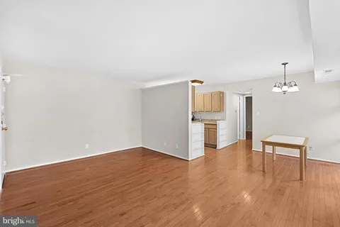 a view of a kitchen with wooden floor and electronic appliances
