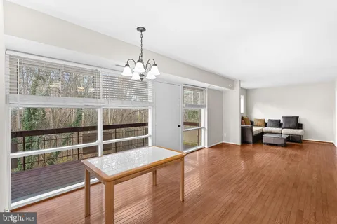 a view of a livingroom with furniture wooden floor and chandelier