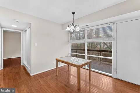 a view of a room with wooden floor and window