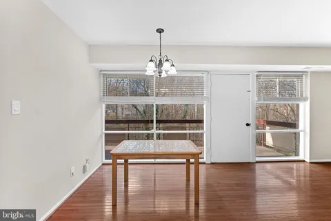 a view of a room with wooden floor and window