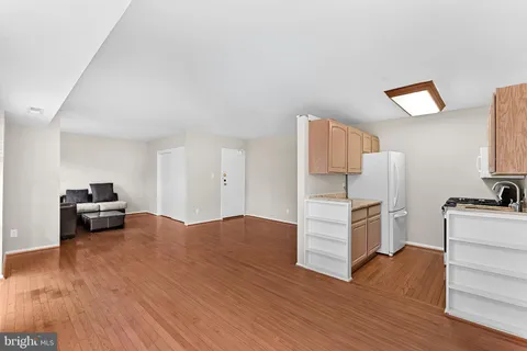 a kitchen with a refrigerator and a stove top oven