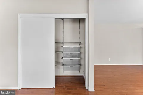 a view of walk in closet with empty racks