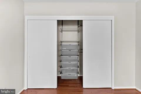 a view of walk in closet with empty racks