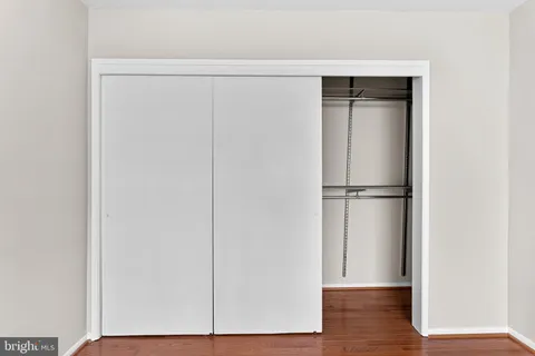 a view of walk in closet with wooden floor