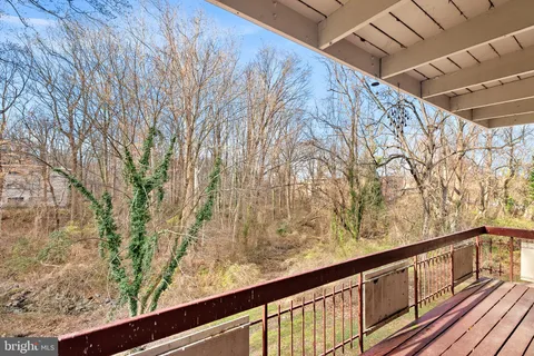 a view of balcony with wooden floor and fence