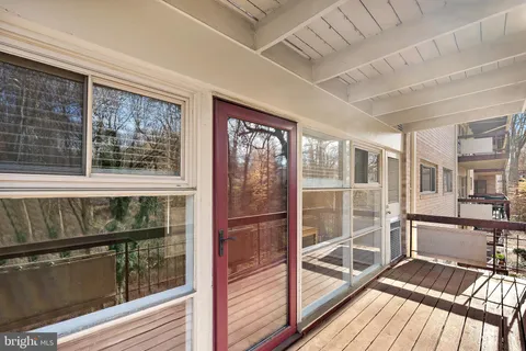 a view of a large room with wooden floor and windows