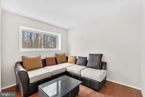 a blue couch sitting next to a white wall