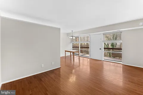 a view of empty room with wooden floor and fireplace