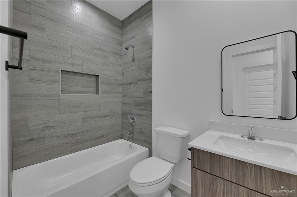 2509 Mockingbird Road, Unit B Weslaco, TX 78596 - Photo 8 of 11 Full bathroom with toilet, tiled shower / bath combo, and vanity
