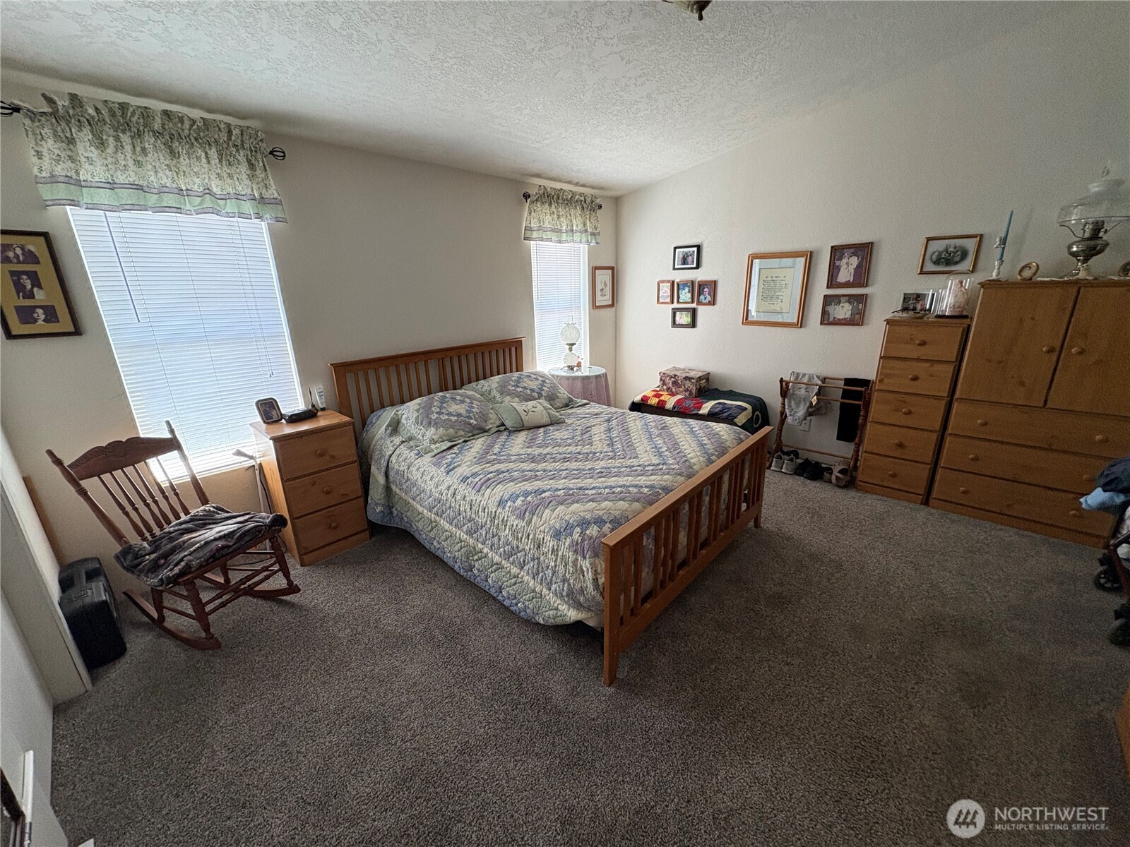 51 Meander Way Aberdeen, WA 98520 - Photo 14 of 22 a bed sitting in a bedroom next to a window and a chair