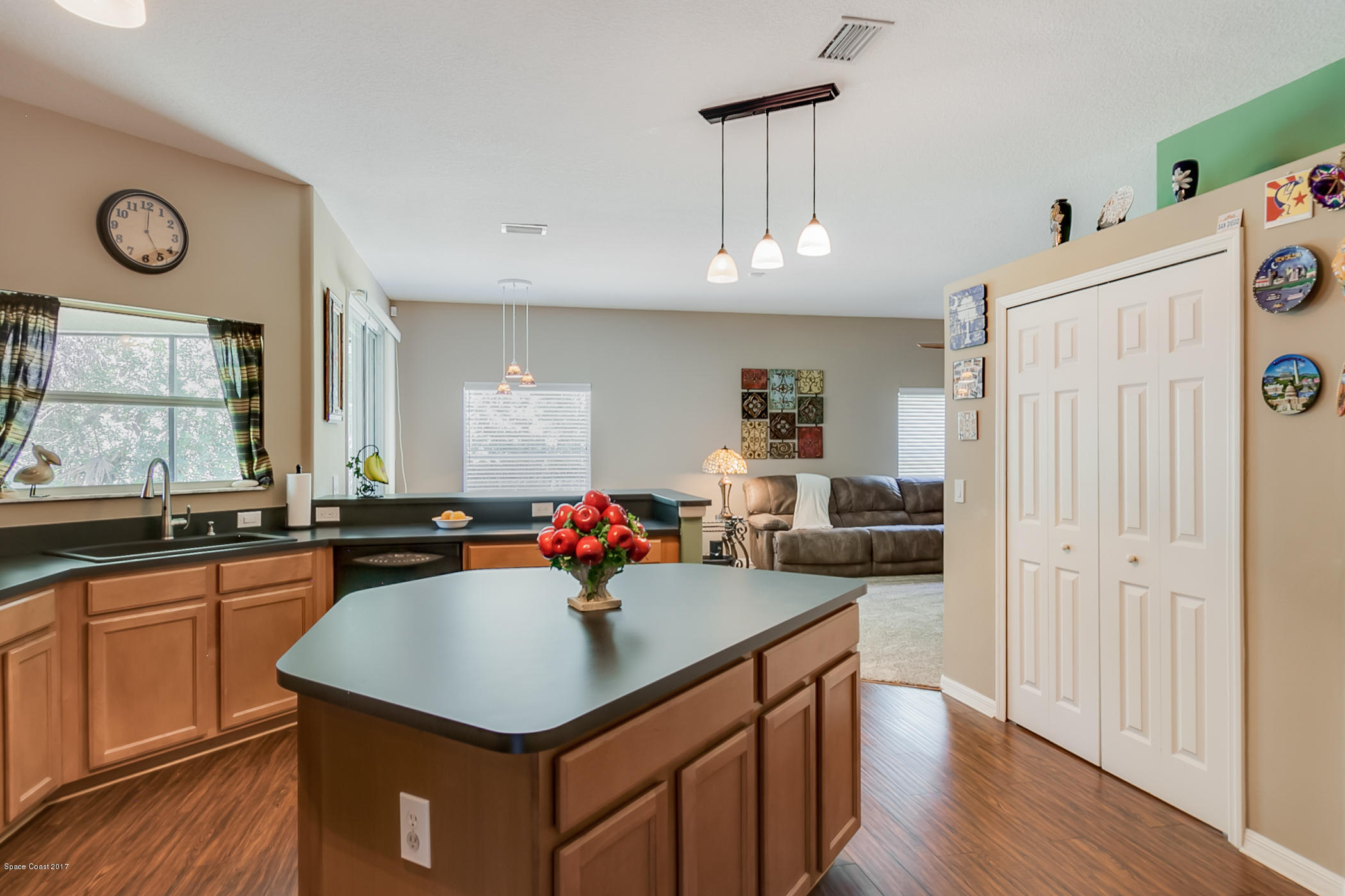 3330 Carter Road Mims, FL 32754 - Photo 12 of 37 a kitchen with a sink a counter top space and living room view