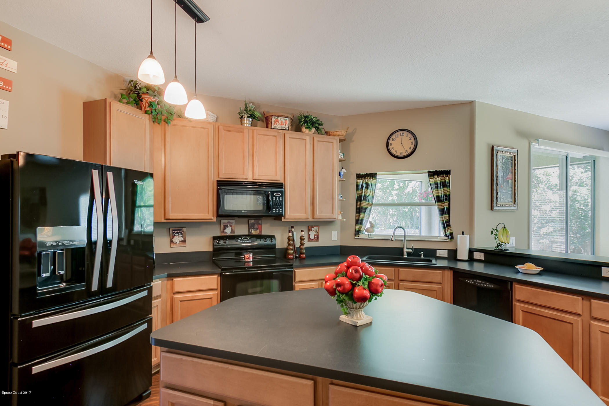 3330 Carter Road Mims, FL 32754 - Photo 13 of 37 a kitchen with a sink a counter top space appliances and cabinets