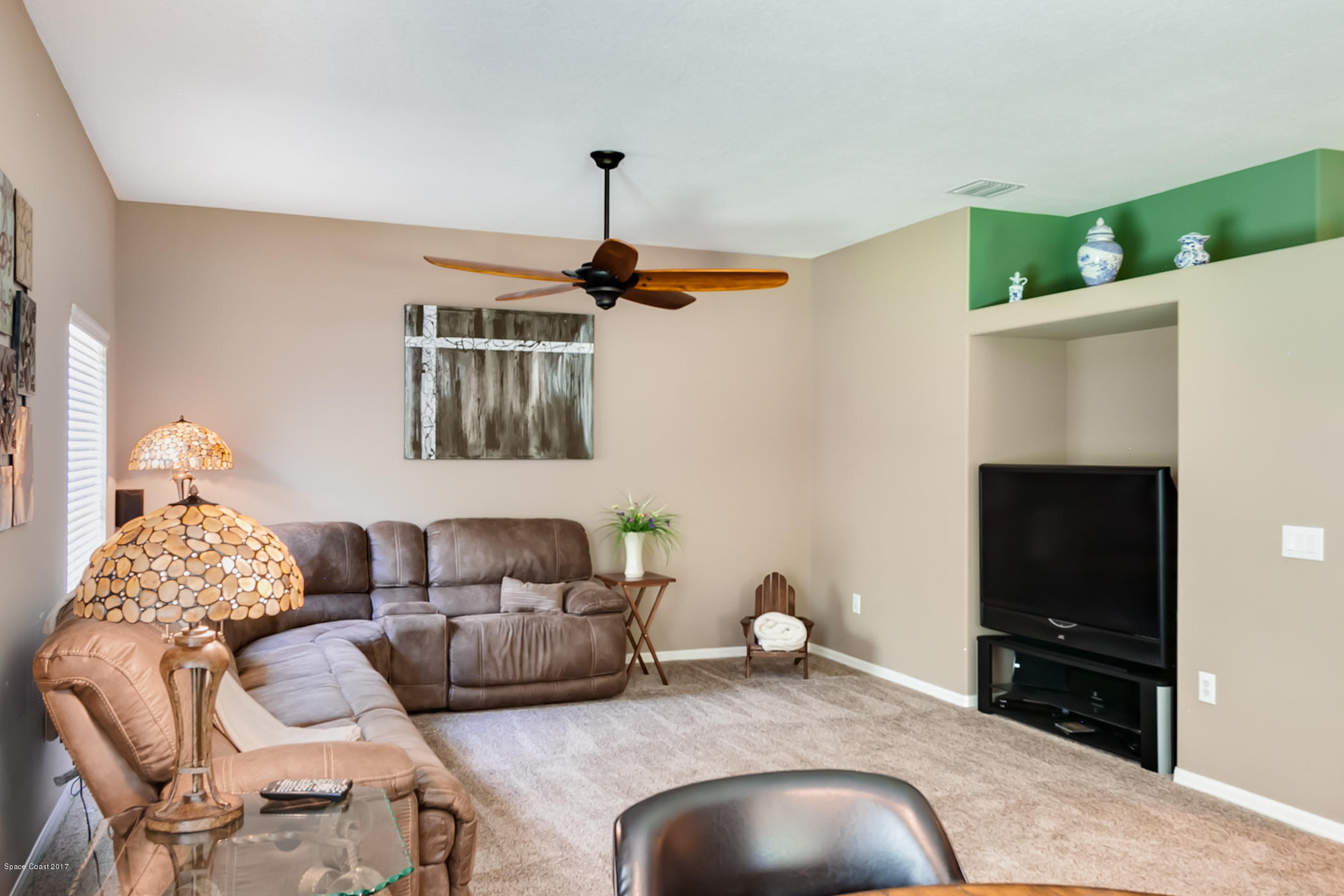3330 Carter Road Mims, FL 32754 - Photo 17 of 37 a bedroom with furniture and a flat screen tv