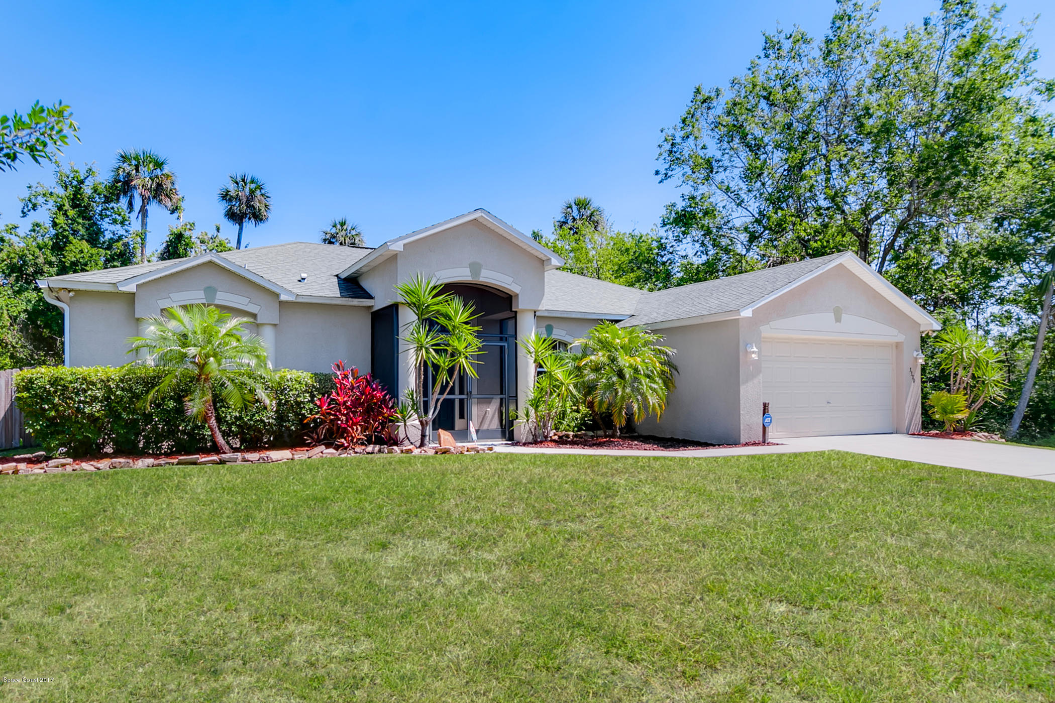 3330 Carter Road Mims, FL 32754 - Photo 3 of 37 a front view of a house with a yard and garage