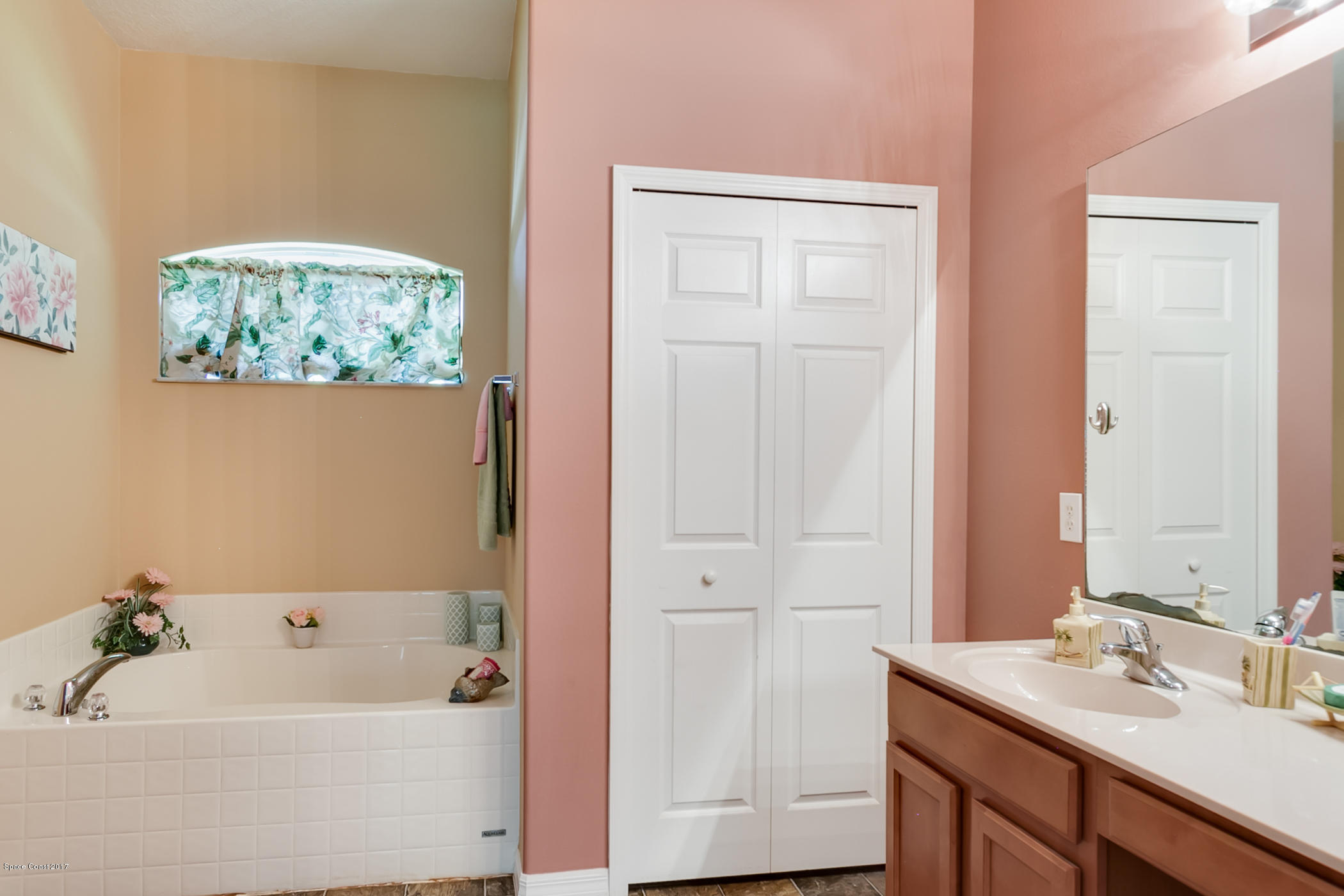 3330 Carter Road Mims, FL 32754 - Photo 23 of 37 a bathroom with a tub a sink and a window