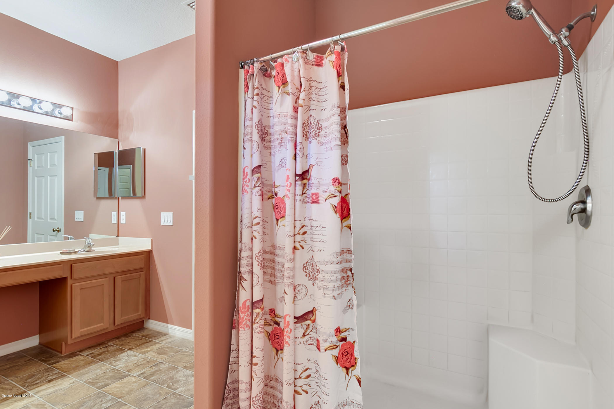 3330 Carter Road Mims, FL 32754 - Photo 25 of 37 a bathroom with a shower curtain and a sink