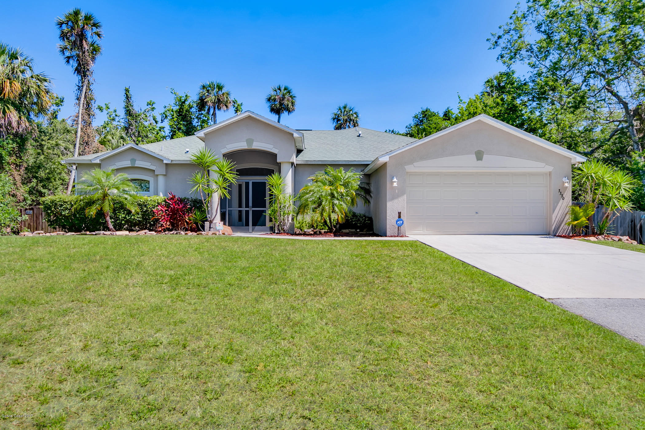 3330 Carter Road Mims, FL 32754 - Photo 4 of 37 a front view of a house with a yard and potted plants