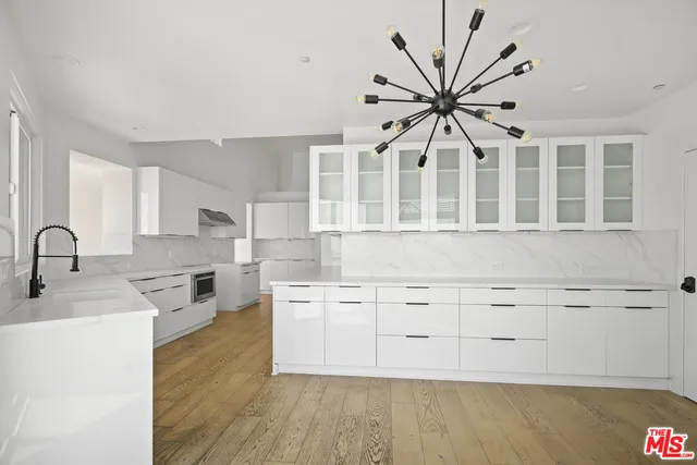 a kitchen with cabinets a sink and appliances