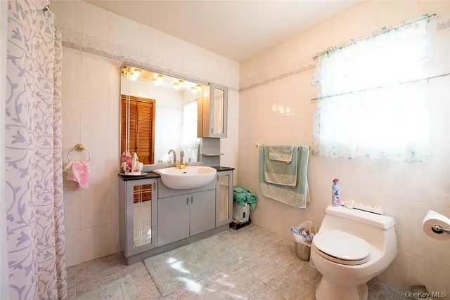 a bathroom with a sink toilet and tub