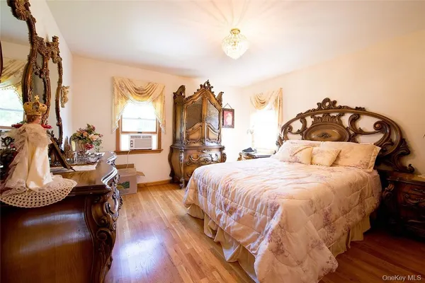 a spacious bedroom with a bed and a chandelier