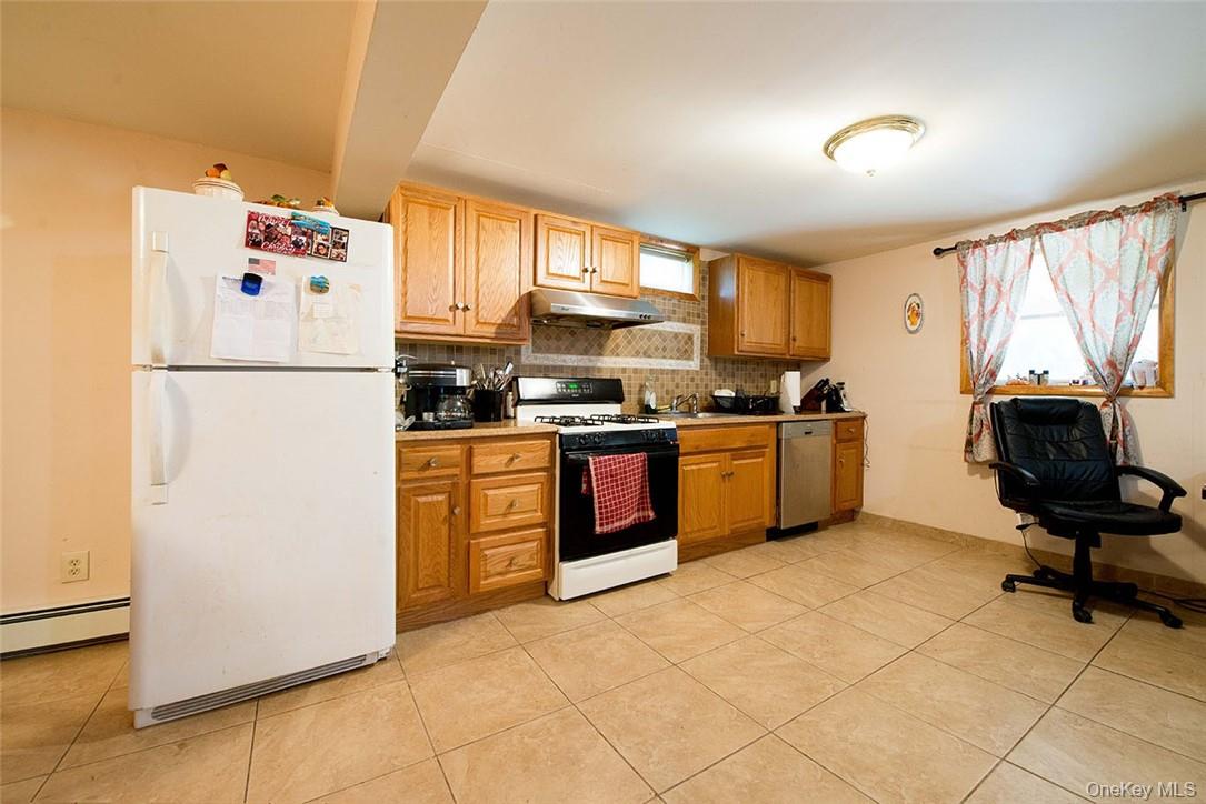 114 Levine Road Kiamesha Lake, NY 12751 - Photo 29 of 36 a kitchen with a refrigerator a stove a sink dishwasher and a refrigerator