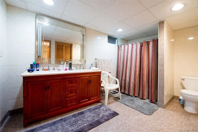 a spacious bathroom with a double vanity sink and a mirror