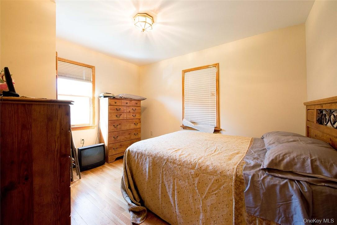 114 Levine Road Kiamesha Lake, NY 12751 - Photo 34 of 36 a bedroom with a bed and wooden floor