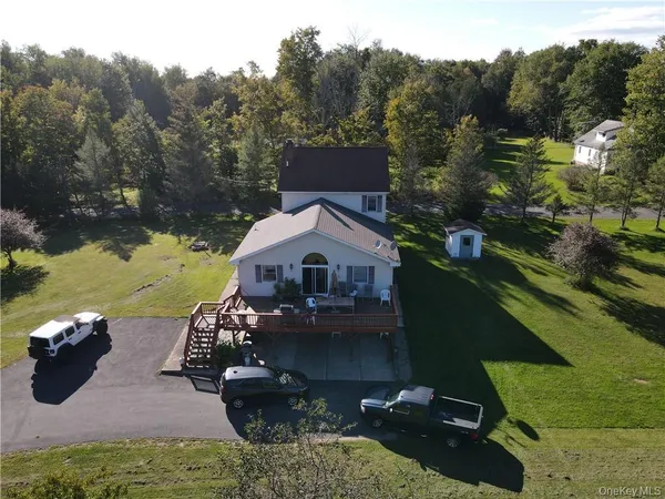 a view of a house with a yard and a pond