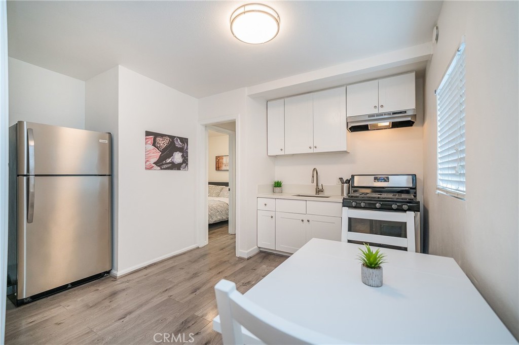 a kitchen with stainless steel appliances a stove a refrigerator and a refrigerator