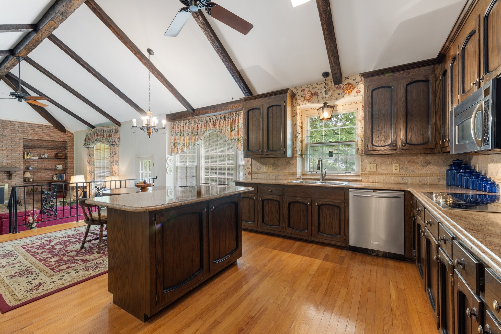 1409 Sneed Road West Franklin, TN 37069 - Photo 11 of 47 a kitchen with granite countertop a sink cabinets and wooden floor