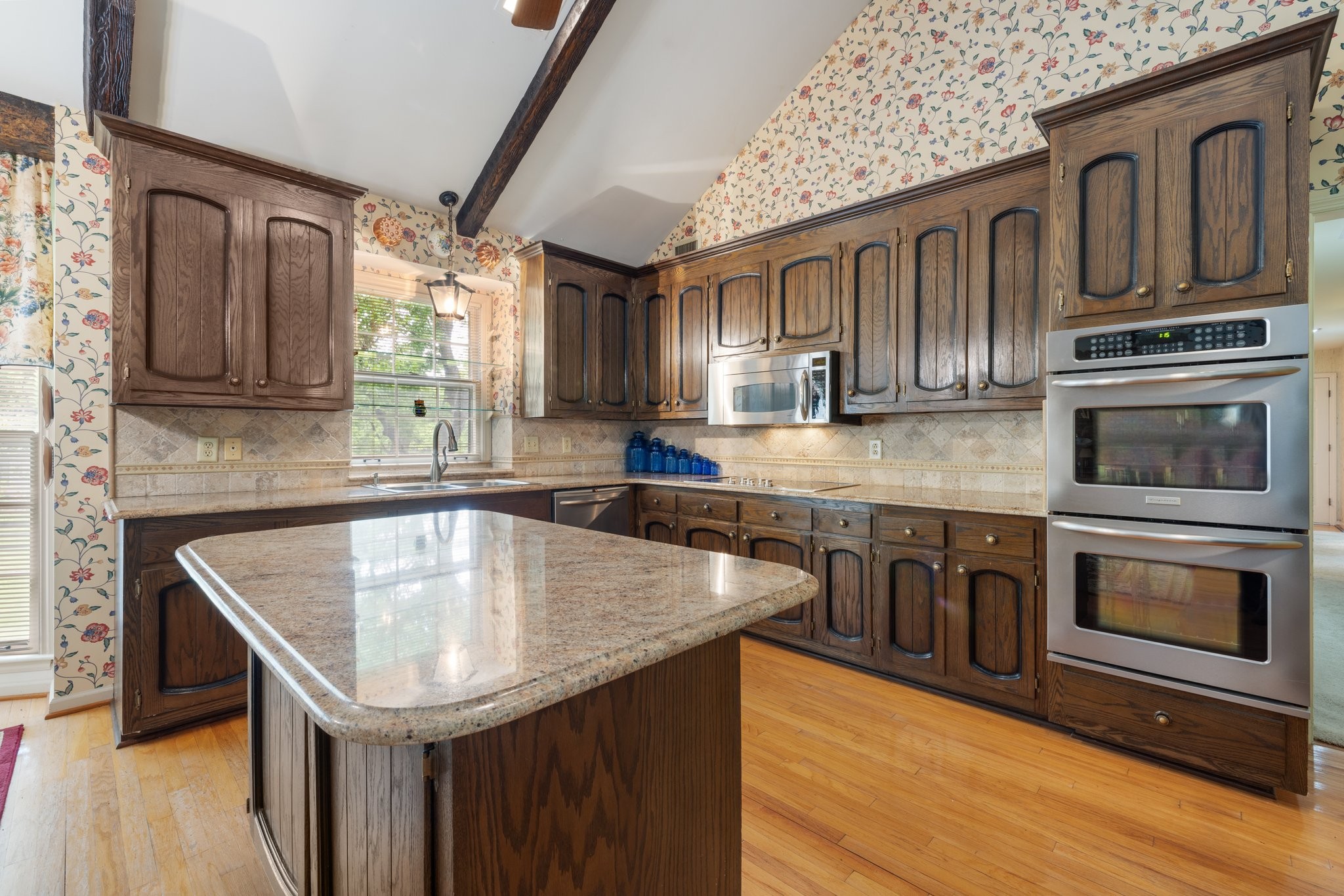 1409 Sneed Road West Franklin, TN 37069 - Photo 12 of 47 a kitchen with stainless steel appliances granite countertop a sink a microwave cabinets and wooden floor