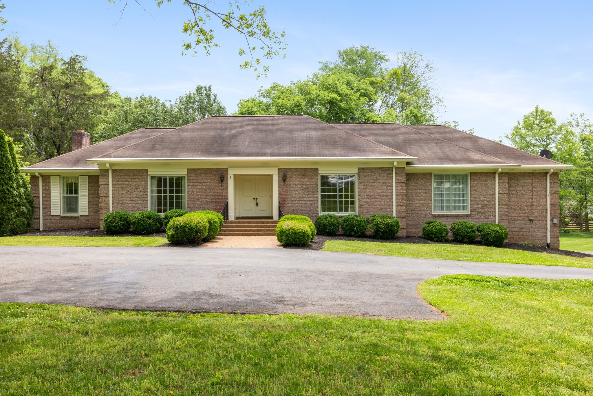 1409 Sneed Road West Franklin, TN 37069 - Photo 2 of 47 a front view of a house with a garden and porch