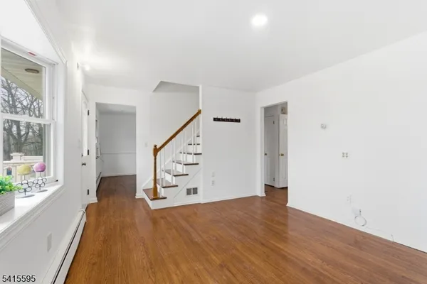 a view of an entryway with wooden floor
