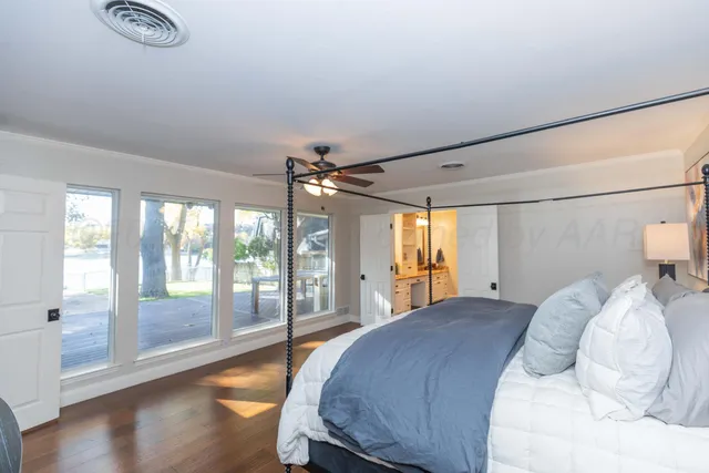 a bedroom with a bed and a ceiling fan